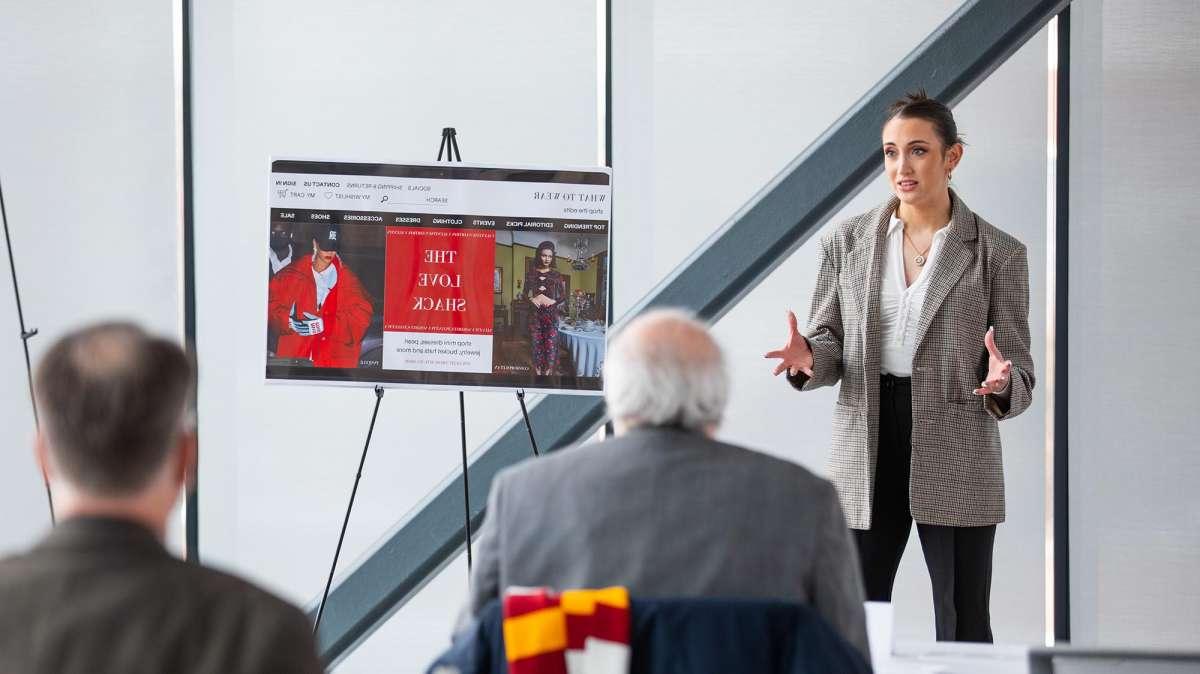 A woman presents her idea to judges during an entrepreneurial pitch competition